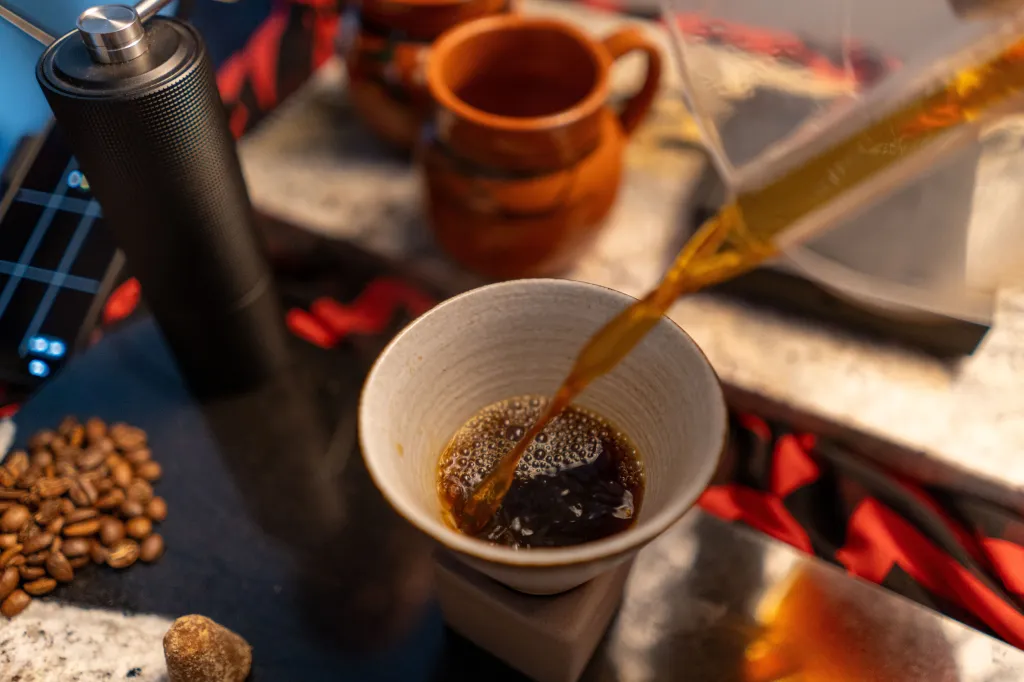 A cup of specialty coffee on a wooden counter.